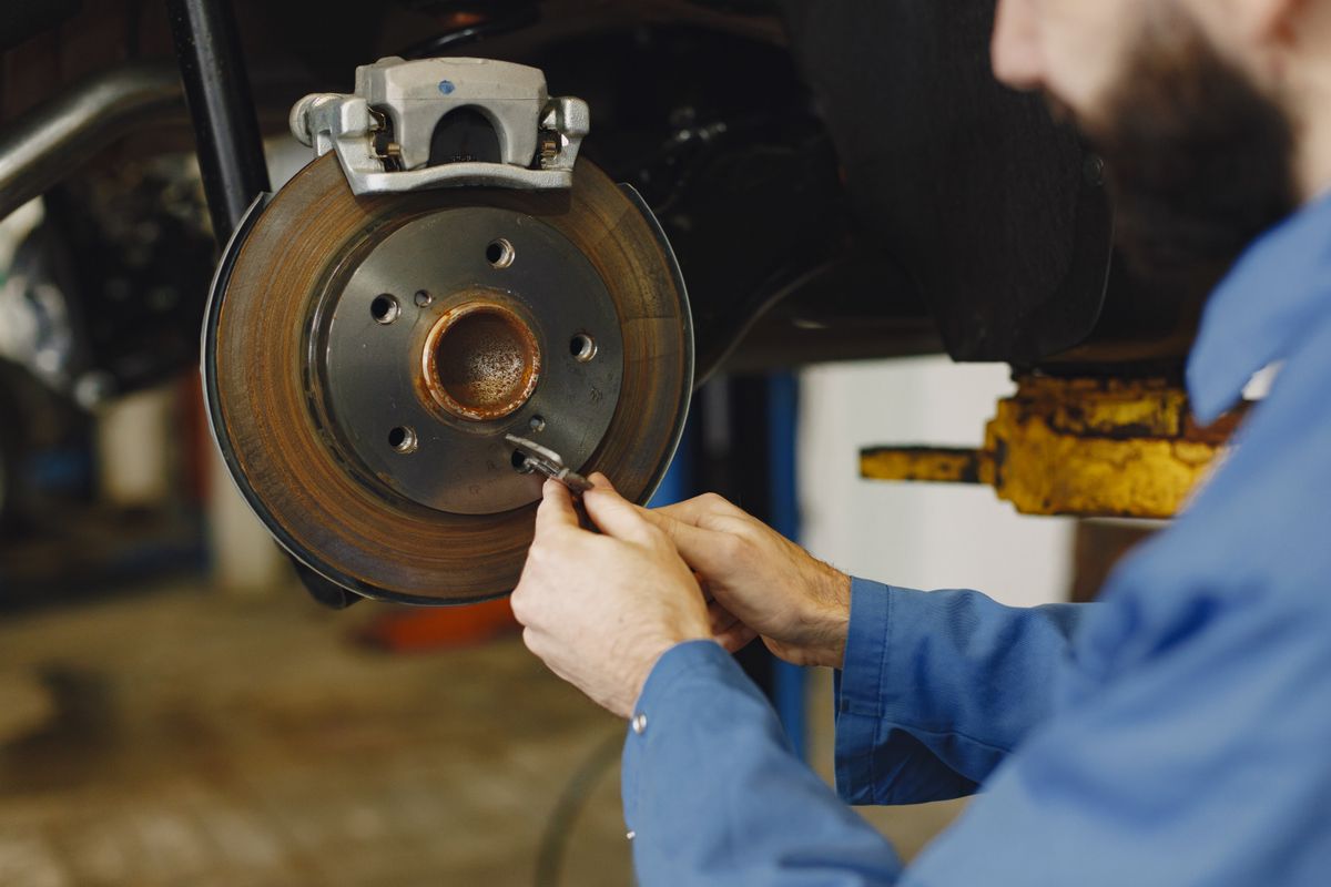 Mechanic replacing brake discs and pads